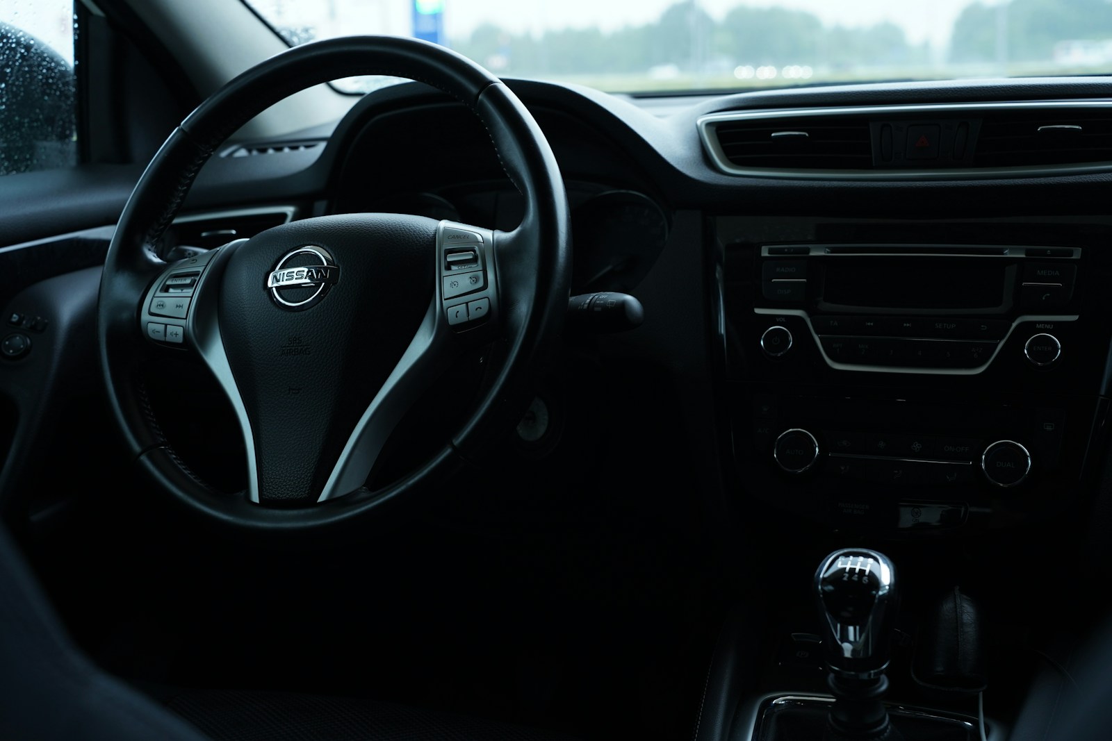 the interior of a car with a steering wheel and dashboard